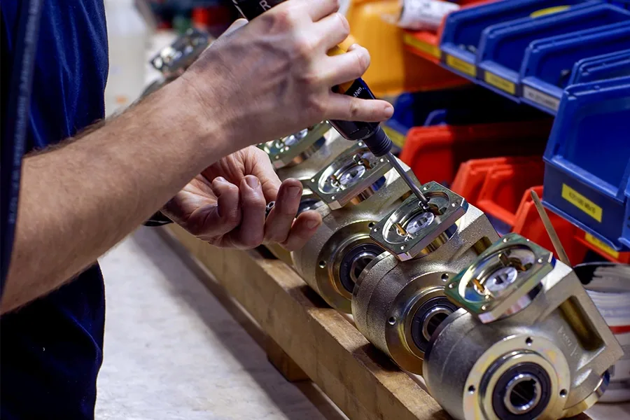 Close-up of a BJ Gear production worker's hand tightening a fastening element on a product