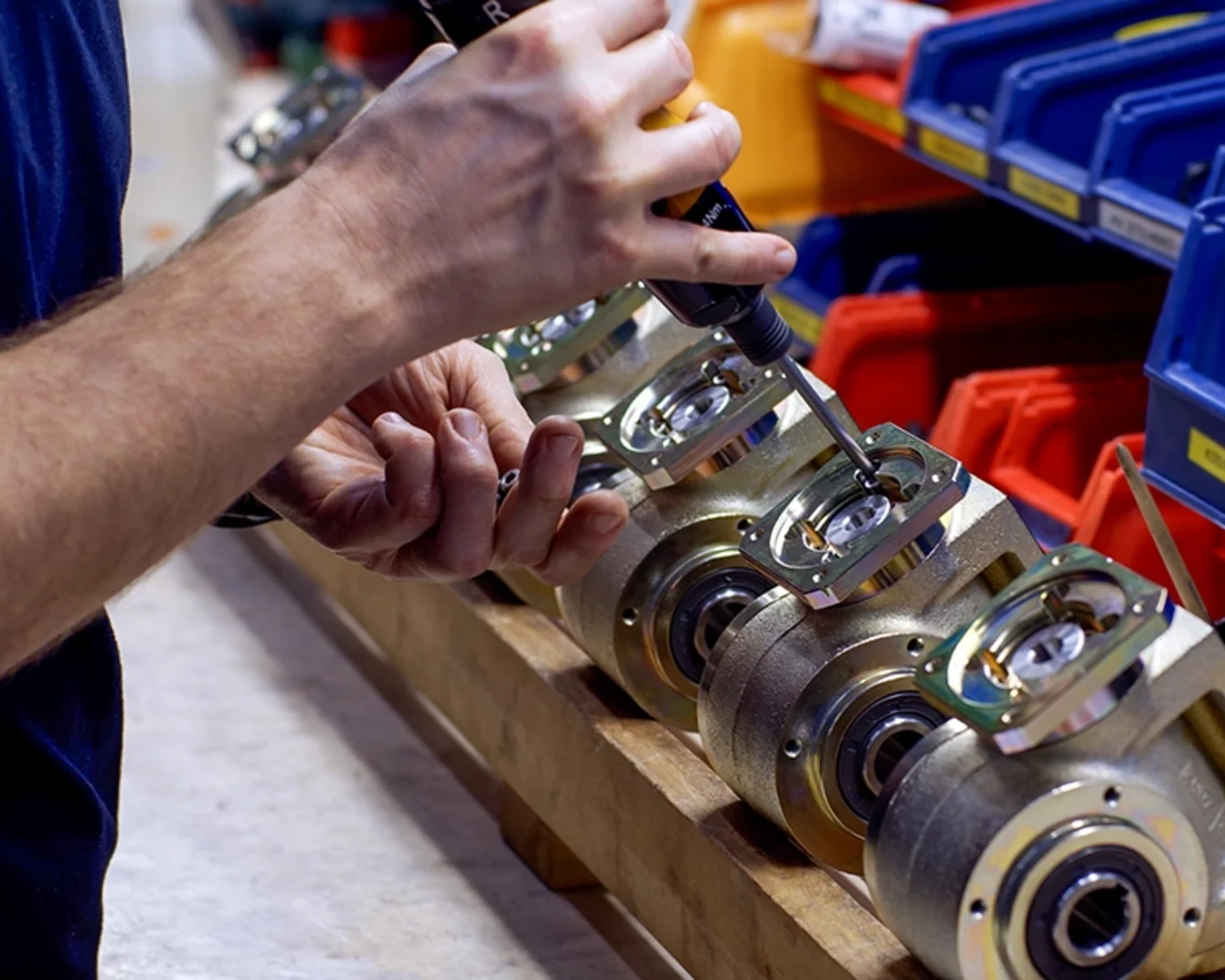 Close-up of a BJ Gear production worker's hand tightening a fastening element on a product