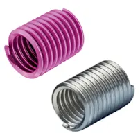 Two KATO threaded inserts, one pink and one silver, made of coiled wire with spiral structure on a white background.