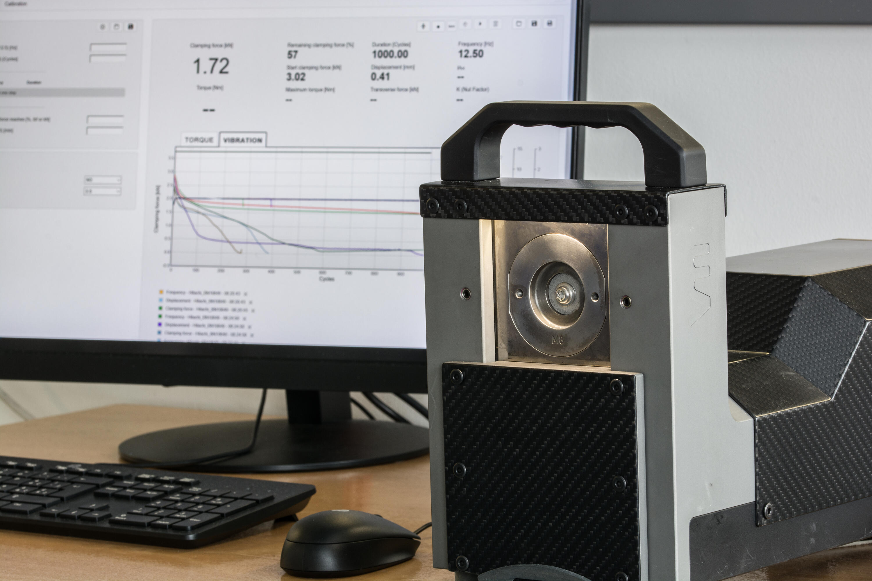 Junker vibration testing equipment with testing machine and results screen.