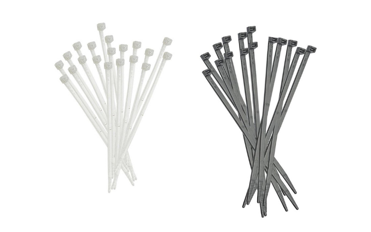 Two heaps of Elematic standard cable ties, one white-colored and one black-colored on white background