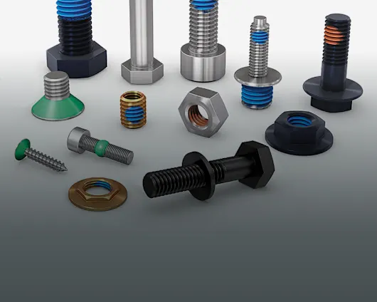 Different screws, nuts, and threaded inserts with different types of coating solutions, such as functional coating patches, on a grey background