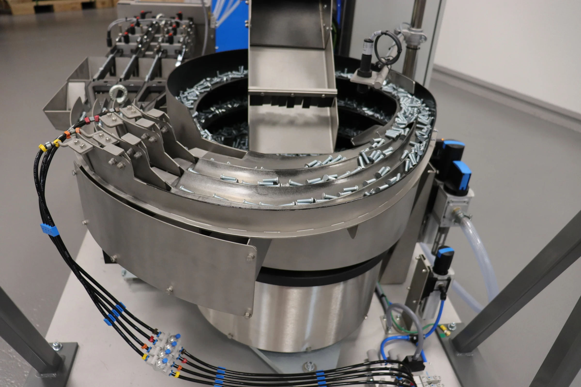 Close-up of the PEMSERTER IN-DIE autofeed system, delivering self-clinching fasteners to insertion presses.