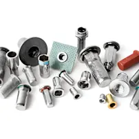 Group of different types and sizes of blind rivet nuts on white background