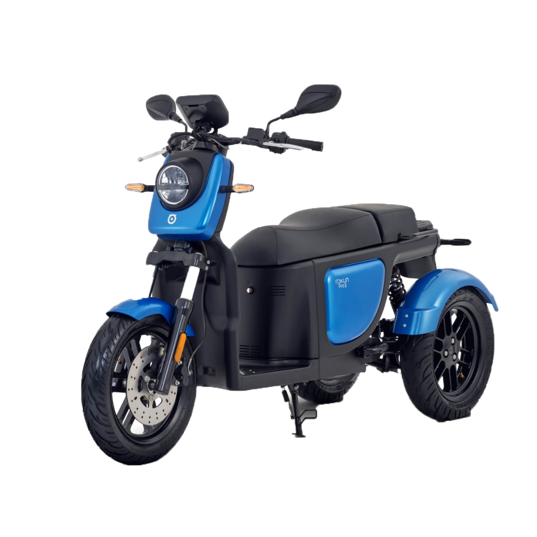 Blue and black electric scooter with a round headlight, two mirrors, and a kickstand, viewed from the front-left angle.