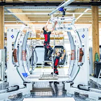 Technicians working on a CWA cabin in a modern manufacturing facility