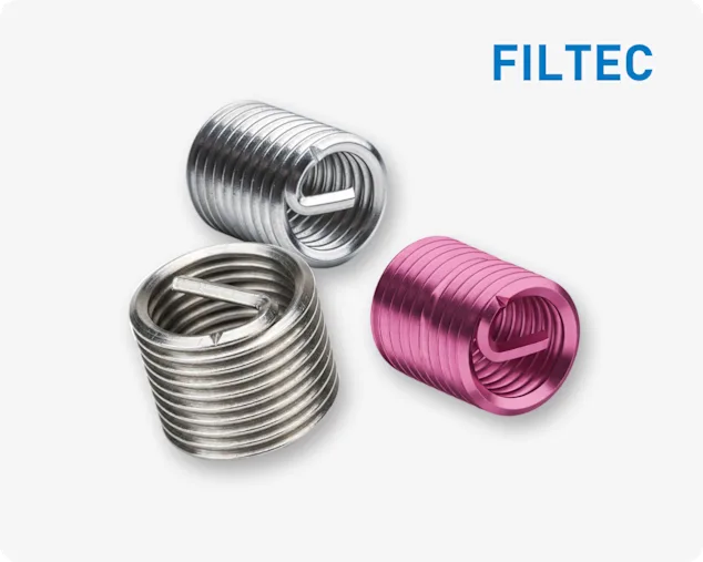 Three FILTEC wire thread inserts, in silver and one pink, with spiral structure on a light grey background and FILTEC logo in the top right corner.