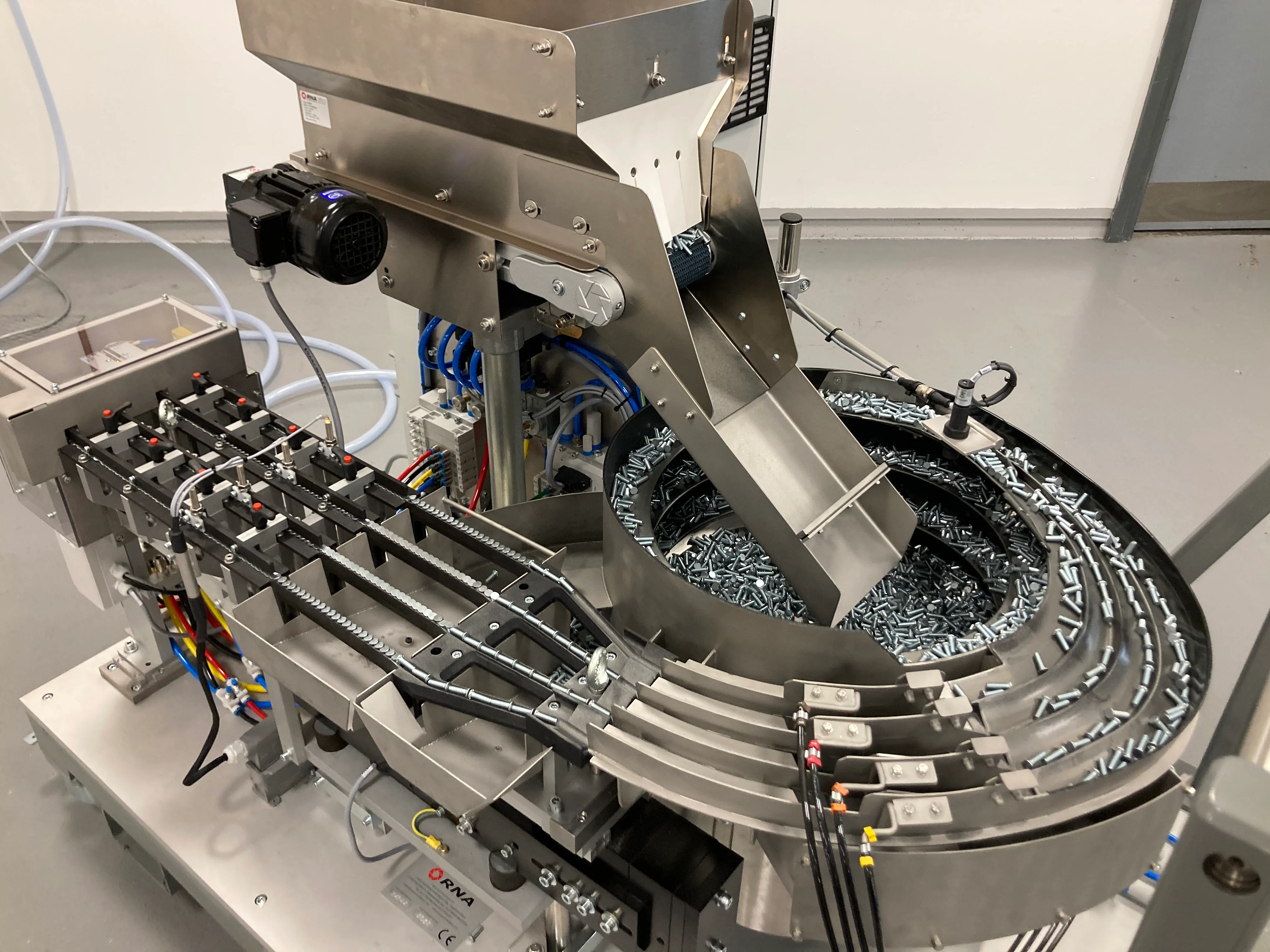 Close-up of the hopper, autofeed system and feeder tracks of the PEMSERTER IN-DIE NextGen Universal Feed Cart.