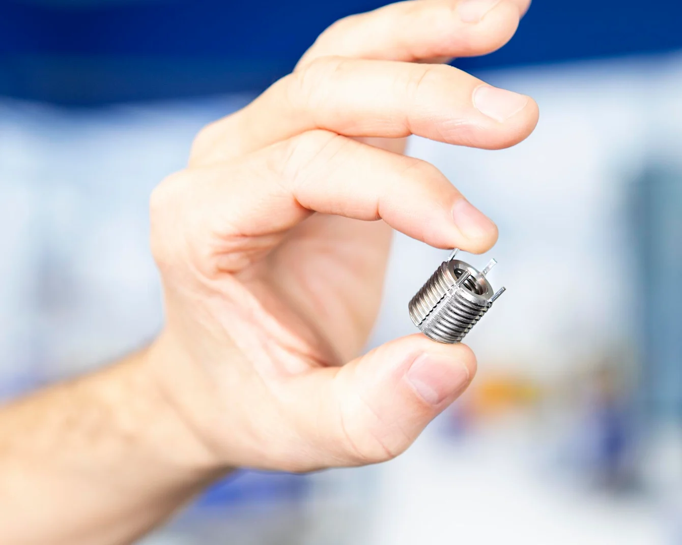 Hand holding a Keenserts threaded insert