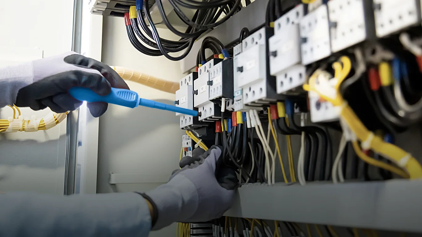Engineer inspecting electrical box ensuring everything is up and running.