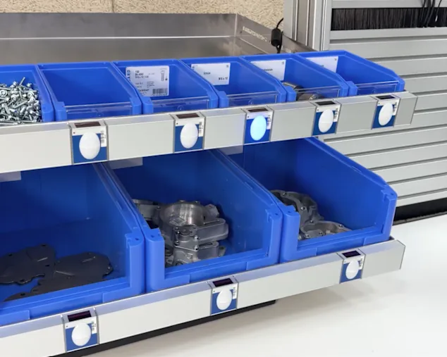 Bossard Pick-to-Light system with blue bins at a workstation in the assembly area