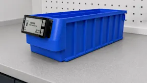 Blue plastic storage bin with smart label displaying product information.