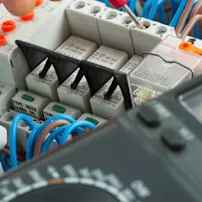 Close-up of electrical wiring and equipment, highlighting intricate connections and essential components for power distribution.