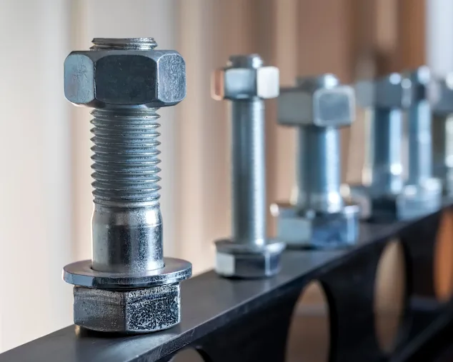 View of fasteners: bolts, nuts, and washers. Bolts assemble two unthreaded components with a nut, while screws are used with threaded components.