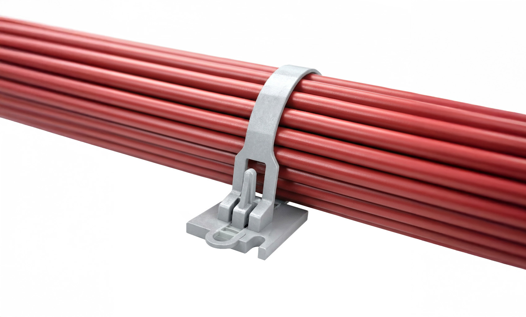 Gray plastic cable tie securing a bundle of red electrical wires or cables against a white background.