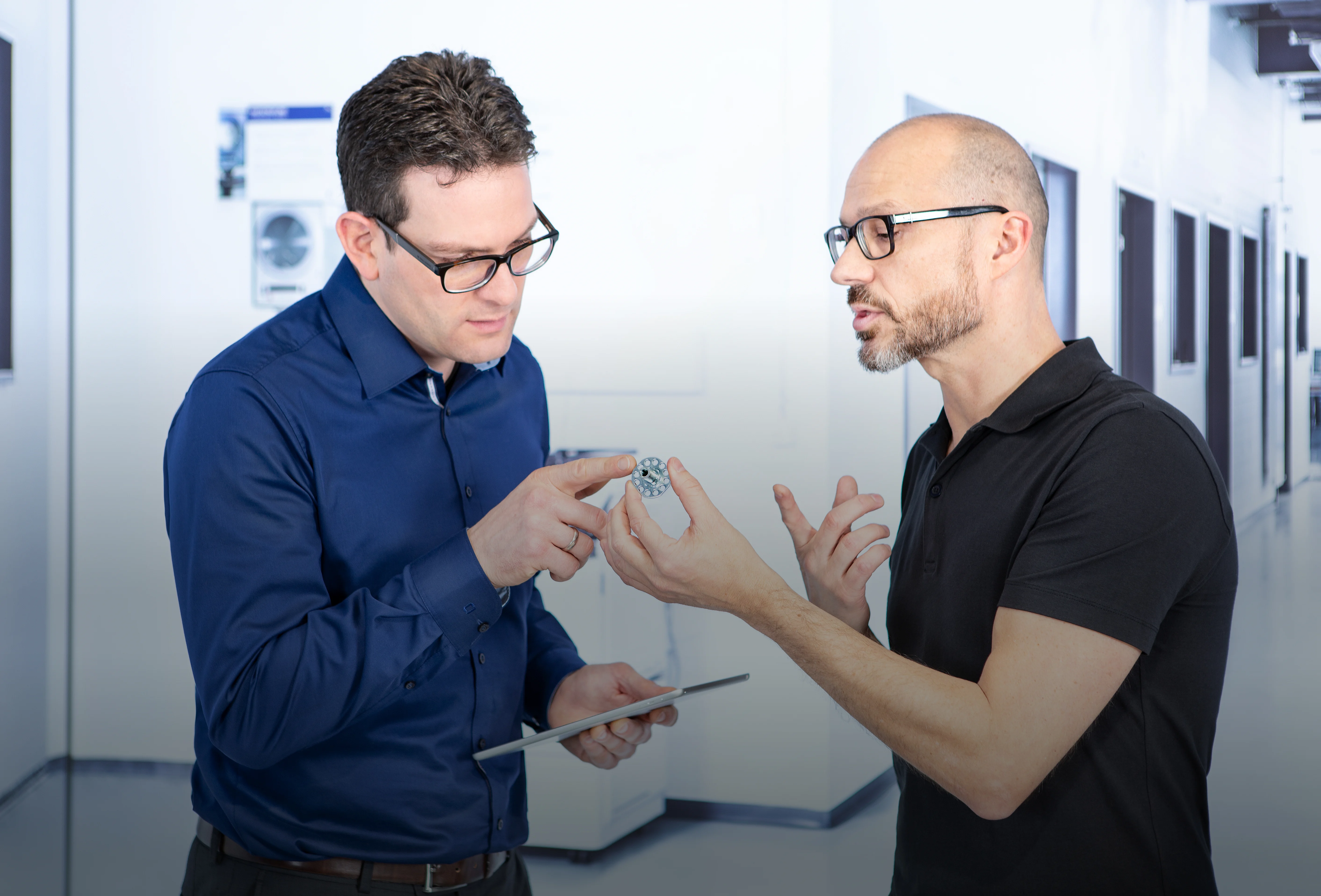 Two people discussing design of a fastener.