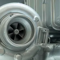 Close-up view of a turbo engine featuring a prominent turbocharger, showcasing intricate details and engineering design.