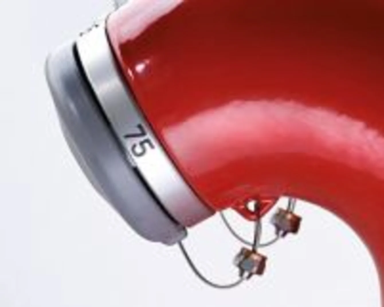 Two rows of red fire hydrants with silver caps and numbers, viewed from the side, creating a symmetrical pattern.