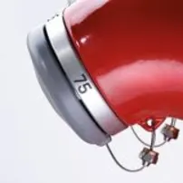 Two rows of red fire hydrants with silver caps and numbers, viewed from the side, creating a symmetrical pattern.