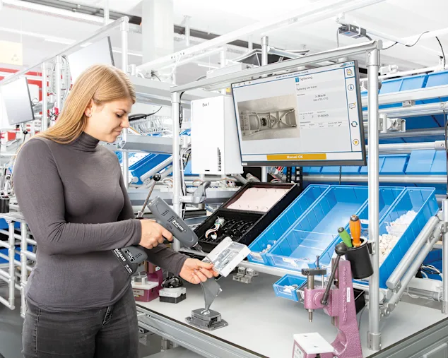 Woman with a Smart Tool guided with ELAM Solutions Work Instructions through process.