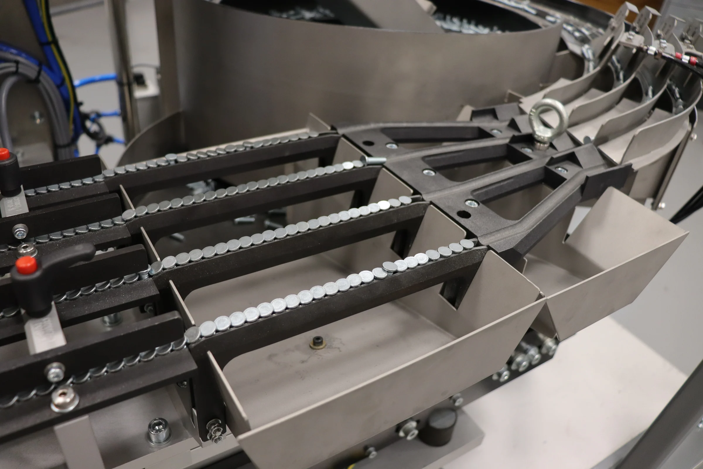 Close-up of the PEMSERTER IN-DIE four-lane feeding system, delivering self-clinching nuts, studs or standoffs to insertion machines.