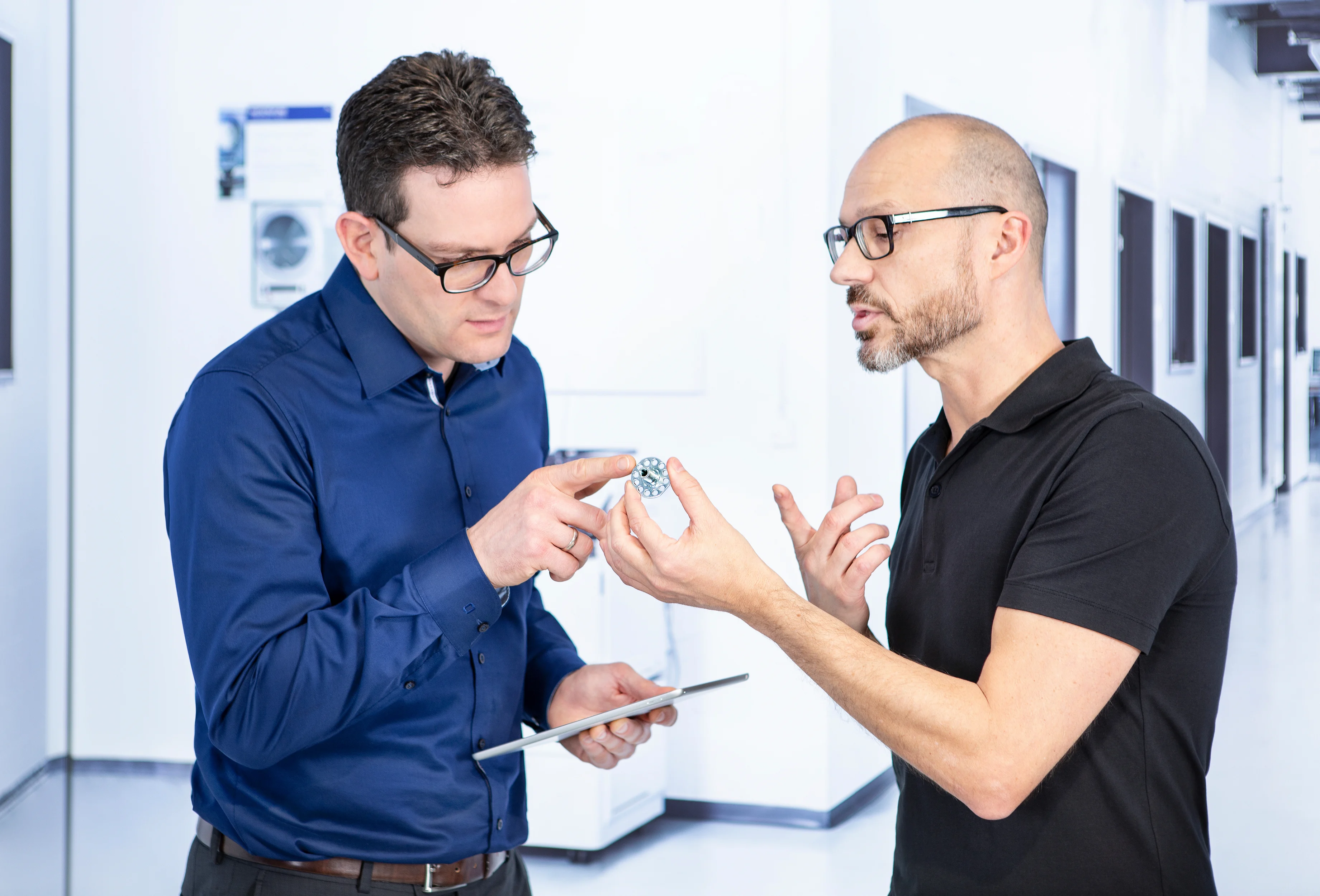 两为工程师在讨论非标紧固件和零部件的设计