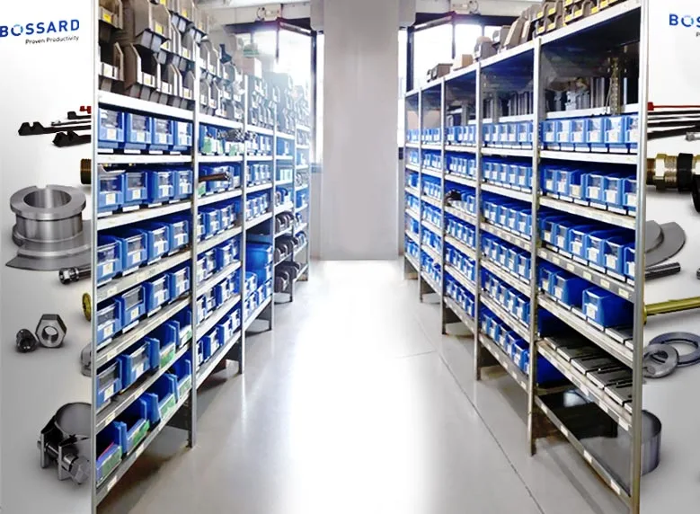 A warehouse aisle with metal shelves filled with blue bins, containing various small parts and tools, under bright lighting.
