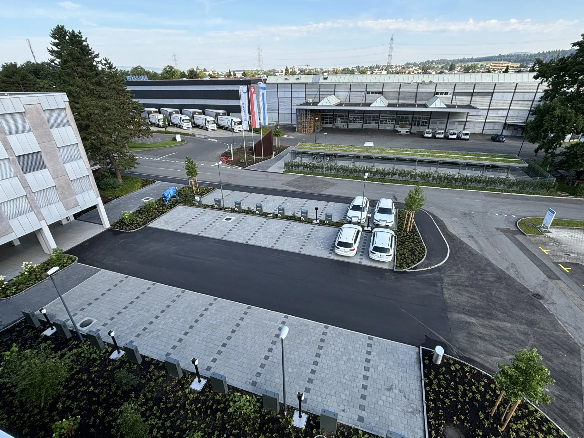 View of the new parking lot at Bossard Switzerland with added charging infrastructure for electric vehicles.