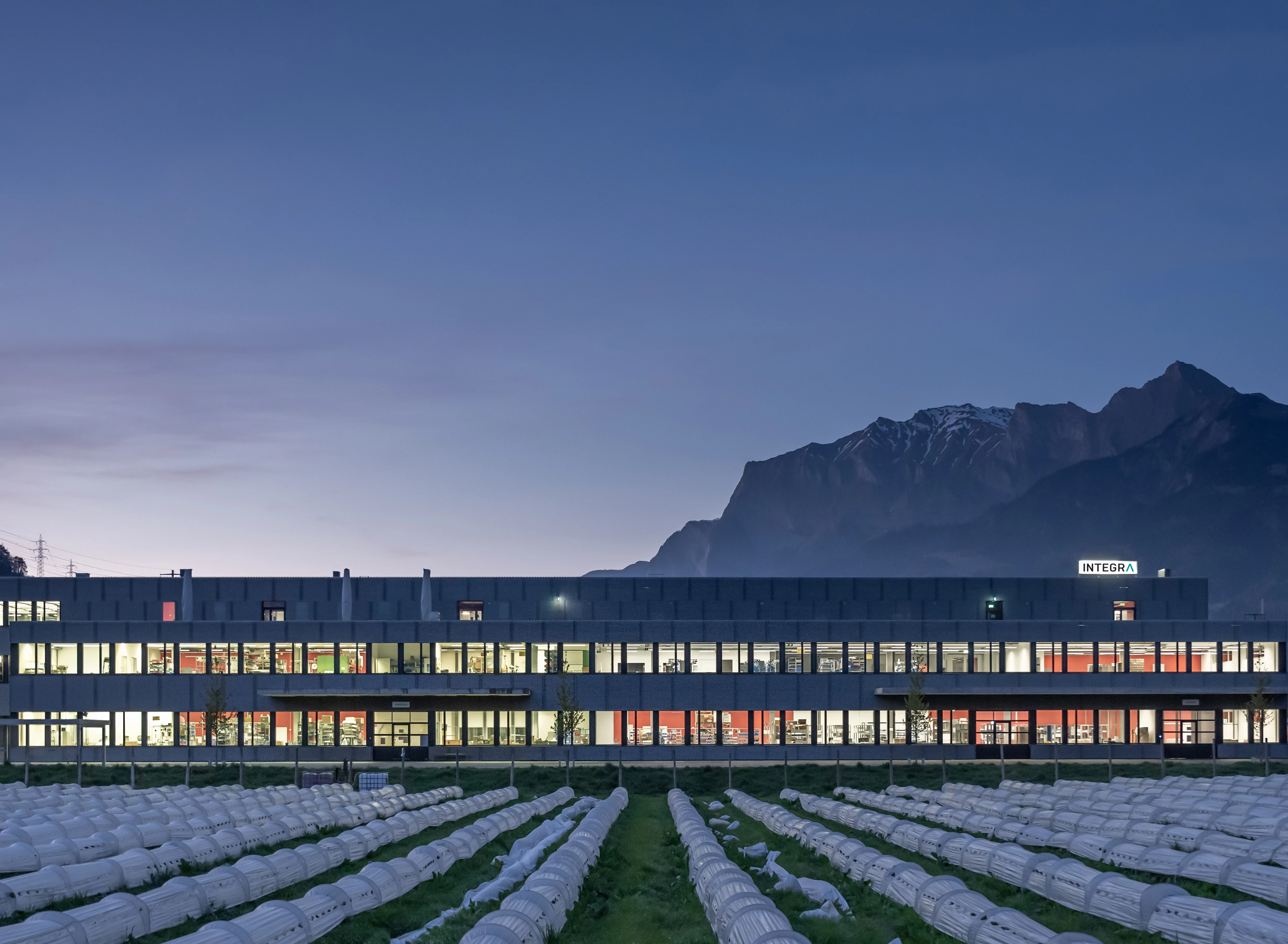 Integra building at dusk with mountains in the background