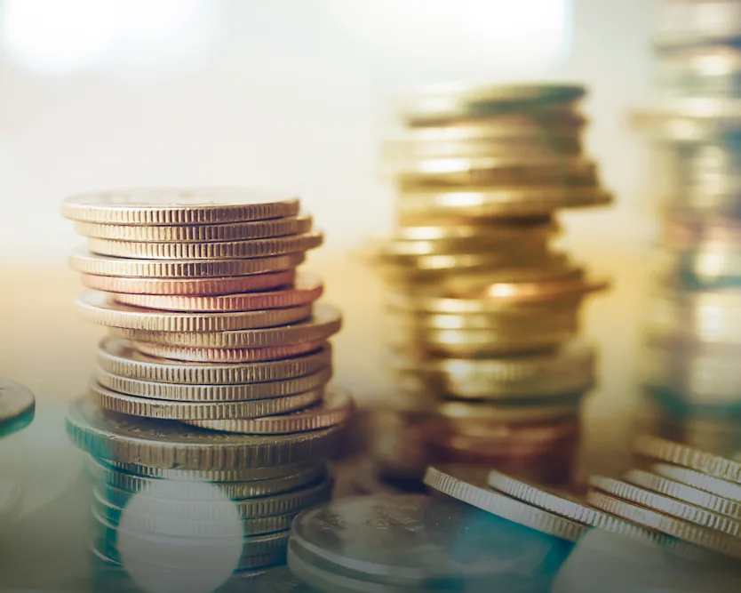 A close-up of several coins stacked into 4 towers