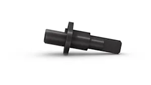 A black turned part, lying on white background