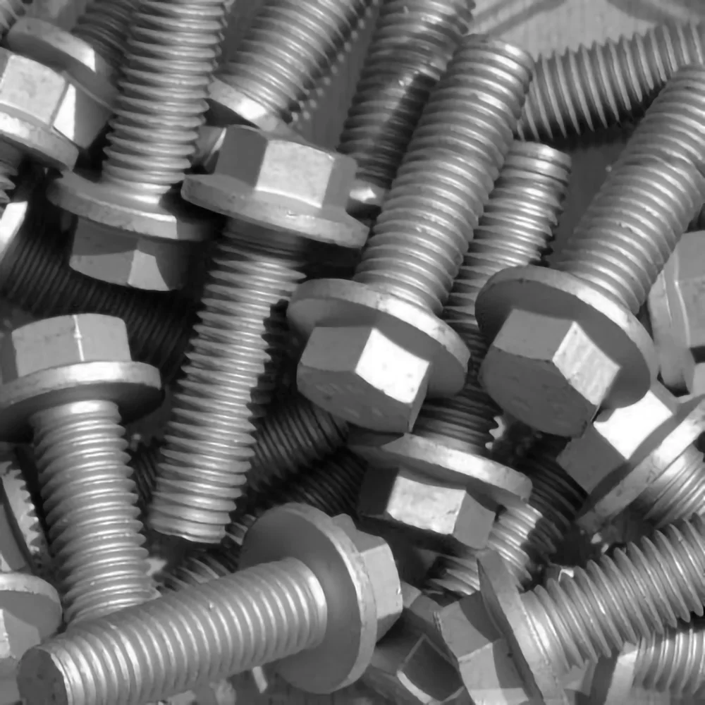 Close-up photograph of multiple metal bolts with hexagonal heads and threaded shafts scattered in a pile.