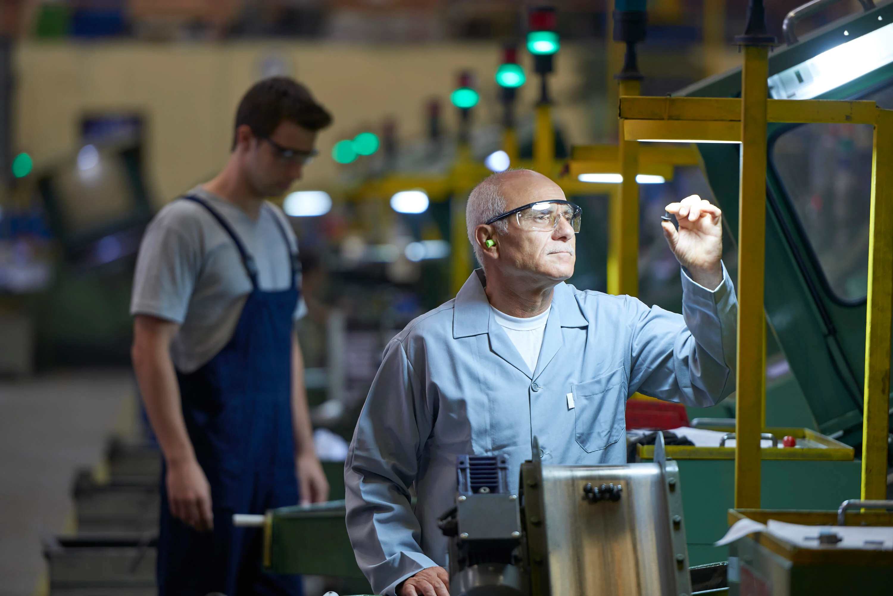 Worker checking product in bolt factory.