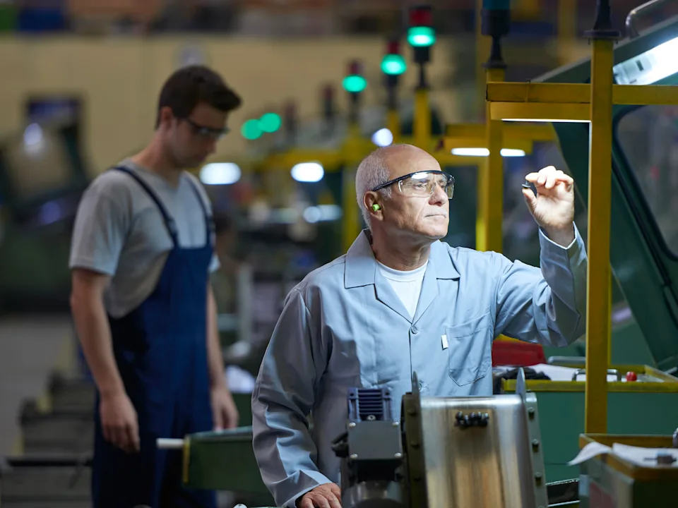 Worker checking product in bolt factory.