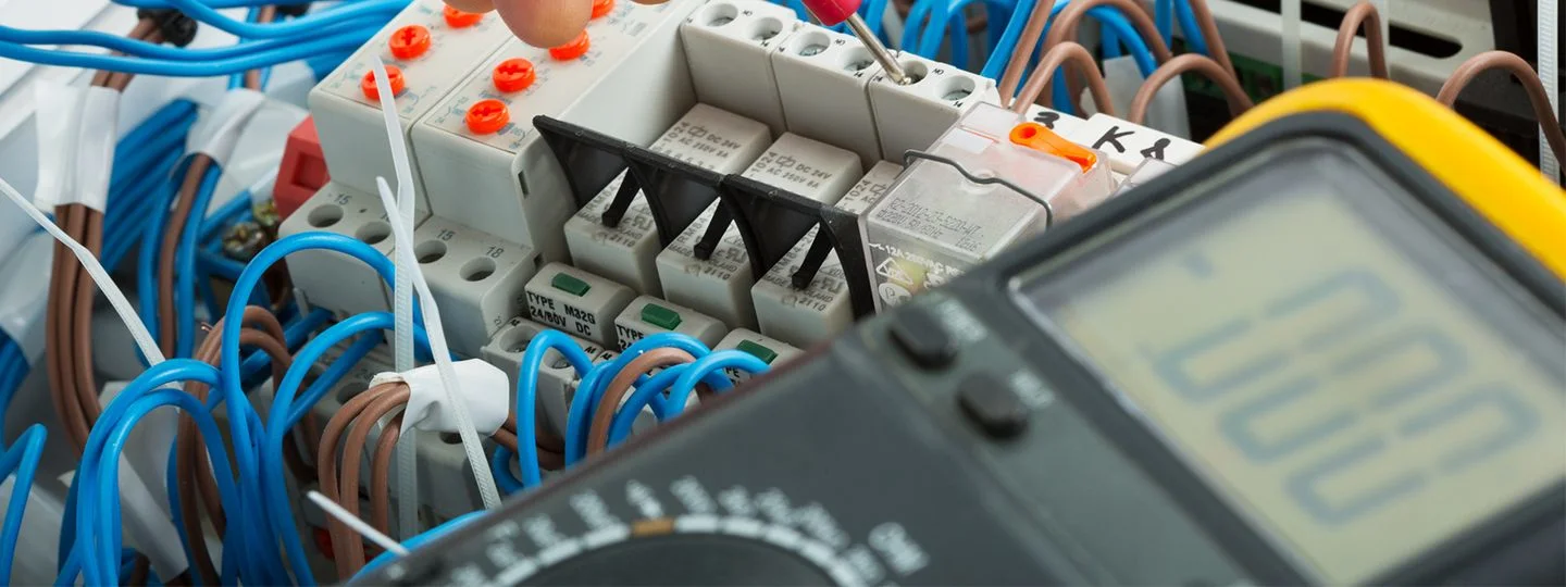 Close-up of electrical wiring and equipment, highlighting intricate connections and essential components for power distribution.