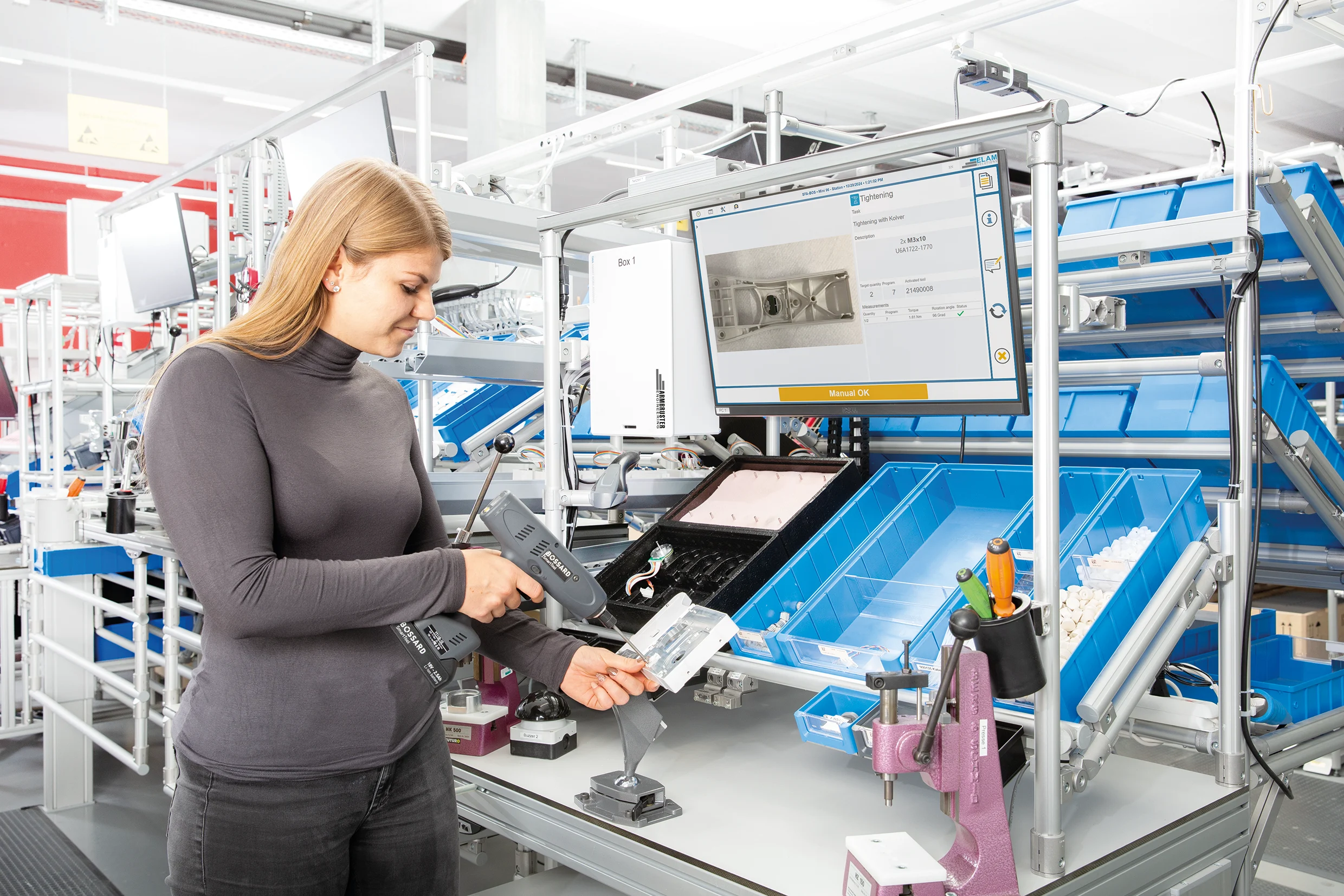 Woman with a Smart Tool guided with ELAM Solutions Work Instructions through process.