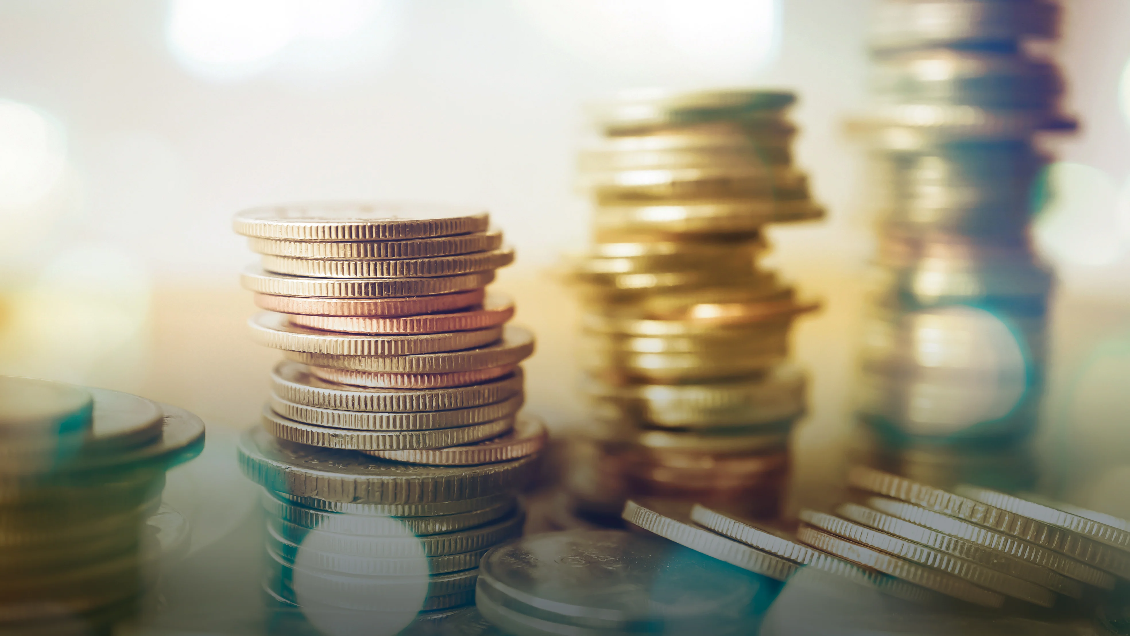 A close-up of several coins stacked into 4 towers